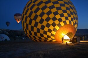 yellow and blue checkered hot air balloon in the dark