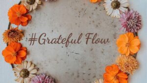 flowers around the word grateful flow
