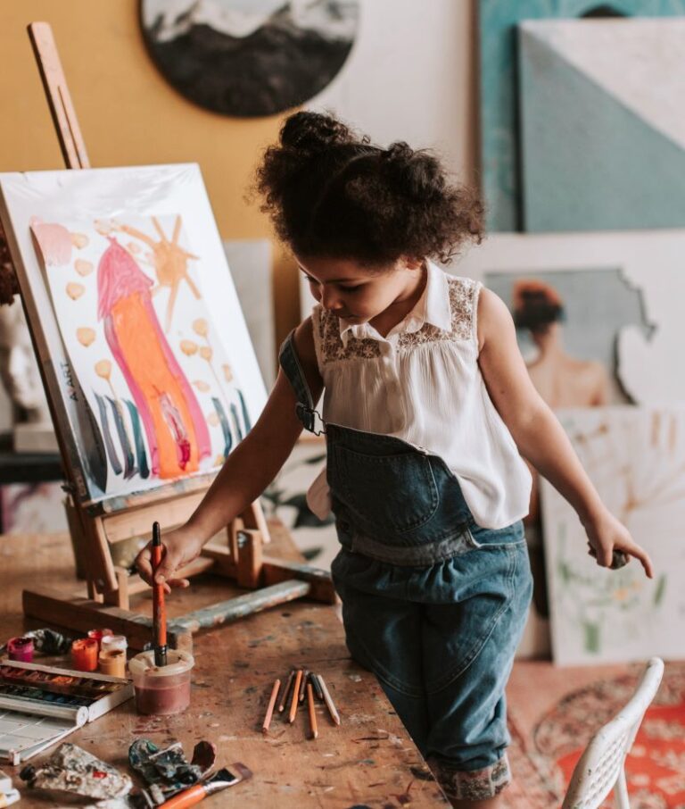 from Pexels: https://www.pexels.com/photo/a-girl-holding a paint brush in a container with water
