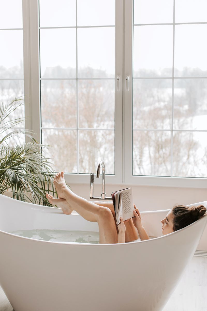 a-person-reading-a-book-in-a-bathtub