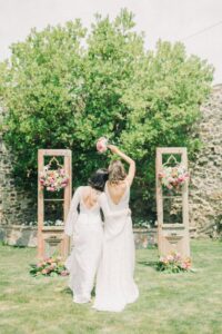 women in white wedding dress standing on grass
