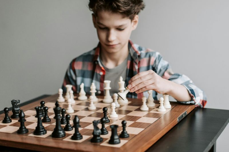 a boy playing a game of chess